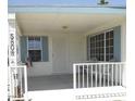 Cozy front porch with seating area, featuring a secure front door, and window shutters for added appeal at 5808 E Lockwood St, Mesa, AZ 85215