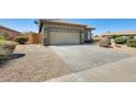 Single-story home with two-car garage and concrete driveway at 6319 W Hilton Ave, Phoenix, AZ 85043