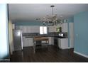 Modern kitchen featuring white cabinets, stainless steel appliances, dark countertops, and a stylish island at 717 E State Ave, Phoenix, AZ 85020