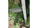 Vintage property sign among lush greenery adds character to the home's entrance at 7252 N Central Ave, Phoenix, AZ 85020