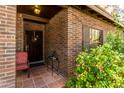 Inviting front porch with red brick and a cozy seating area, creating a warm welcome to the home at 930 E Page St, Gilbert, AZ 85234