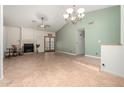 Spacious living room with a fireplace, ceiling fan, tile flooring, and large doors to let in natural light at 930 E Page St, Gilbert, AZ 85234