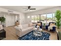 Inviting living room featuring a large window, stylish furnishings, and bright wood floors at 9602 N 5Th Ave, Phoenix, AZ 85021