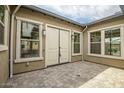 A private courtyard featuring neutral stone pavers and framed by the home's exterior at 9705 E Sector Dr, Mesa, AZ 85212