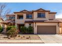 Charming two-story home features a neutral color palette and a well-maintained front yard at 10313 W Windsor Ave, Avondale, AZ 85392