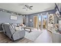 Open living area featuring patio access, stylish furnishings, and plenty of natural light at 11550 W Mule Deer Ct, Surprise, AZ 85378