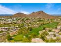 Picturesque aerial showcases the community, golf course, and the scenic mountain backdrop at 13614 N 12Th Way, Phoenix, AZ 85022