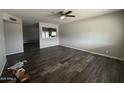 Spacious living room featuring modern wood-style flooring and neutral paint at 1404 S Spencer --, Mesa, AZ 85204