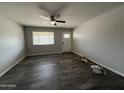Inviting living room with wood-style flooring, a front door, and a bright window at 1404 S Spencer --, Mesa, AZ 85204