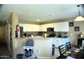 Bright kitchen with white cabinets, granite countertops, and stainless steel appliances at 1417 E Rosebud Dr, San Tan Valley, AZ 85143