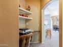A cozy office nook has a printer on the counter and open shelves for storage at 14250 W Wigwam Blvd # 121, Litchfield Park, AZ 85340