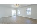 Open-concept living area with light wood floors, large windows and sliding glass door at 1450 E Topeka Dr, Phoenix, AZ 85024