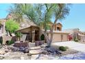 Beautiful home featuring stone accents, a desert landscape, and a stone walkway at 14833 S 14Th Pl, Phoenix, AZ 85048