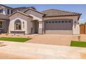 Charming single-story home with a manicured front yard, tile roof and a two car garage at 15620 W Georgia Dr, Surprise, AZ 85379