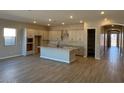 Open kitchen with island, white cabinets, granite countertops, and stainless steel appliances at 15620 W Georgia Dr, Surprise, AZ 85379