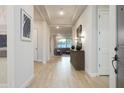 Inviting entryway featuring wood floors leading to an open-concept living area at 15695 W Christy Dr, Surprise, AZ 85379