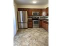 Kitchen with stainless steel appliances, tile floor, and backsplash at 1750 E Mateo Cir # 106, Mesa, AZ 85204