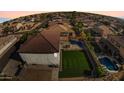 Aerial view of a backyard featuring a pool, grass area, and privacy fence at 23214 N 106Th Ave, Peoria, AZ 85383