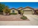 Charming single-story home featuring a well-manicured front yard with desert landscaping and a two-car garage at 2440 W Arroyo Way, San Tan Valley, AZ 85144