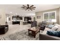 Open-concept living space featuring a large rug, comfortable sofas, and a view into the modern kitchen at 2440 W Arroyo Way, San Tan Valley, AZ 85144