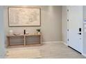 Light and airy entryway featuring tile flooring, a modern console table and decor at 3669 E Boot Track Trl, Gilbert, AZ 85296