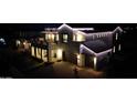 Charming two-story home glowing at night, complete with a spacious balcony and a two-car garage at 3669 E Boot Track Trl, Gilbert, AZ 85296