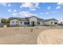 A lovely front exterior showcases an attractive house with a circular driveway and desert-friendly landscaping at 3933 E Freeman Ln, San Tan Valley, AZ 85140