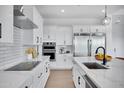 Modern kitchen with stainless steel appliances, white cabinets, and center island at 3933 E Freeman Ln, San Tan Valley, AZ 85140