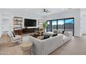 Open living room featuring modern furniture and large sliding glass doors to outdoors at 3933 E Freeman Ln, San Tan Valley, AZ 85140