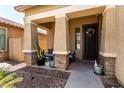 Inviting front porch with textured columns and cozy seating with a desert motif at 4061 E Torrey Pines Ln, Chandler, AZ 85249