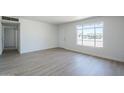 Spacious living room with luxury vinyl plank flooring and bright natural lighting at 4209 N 48Th Dr, Phoenix, AZ 85031