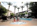 Community pool and hot tub with lounge chairs and palm trees enhance outdoor living at this complex at 4343 N 21St St # 213, Phoenix, AZ 85016