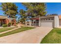 Attractive single-Gathering home with a cozy front patio, grassy lawn, and a two-car garage at 45 Leisure World -- # 45, Mesa, AZ 85206