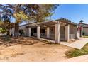 Front yard with covered patio featuring columns and a neutral facade at 45 Leisure World -- # 45, Mesa, AZ 85206