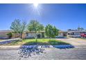 Quaint home with mature landscaping, a paved driveway, and a sunlit facade at 5038 N 20Th Ave, Phoenix, AZ 85015
