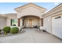 Covered entrance with elegant chandelier, comfortable seating, and desert landscaping accents at 5221 N Tuthill Rd, Litchfield Park, AZ 85340