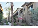 Beautiful townhouse exterior featuring meticulously maintained landscaping and multiple balconies at 6565 E Thomas Rd # 1128, Scottsdale, AZ 85251