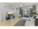Spacious living room with hardwood floors, ample seating, and balcony overlooking the complex at 6565 E Thomas Rd # 1128, Scottsdale, AZ 85251