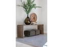 Artistic foyer with sleek console table, decorative accessories, and plush ottoman seating below at 7501 N Eucalyptus Dr, Paradise Valley, AZ 85253