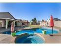 An inviting backyard pool with a spa and ample patio space for outdoor enjoyment at 7810 W Beryl Ave, Peoria, AZ 85345