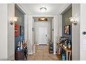 Inviting foyer with elegant lighting, neutral paint and tile, and wine decor at 7936 S 7Th Way, Phoenix, AZ 85042