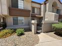 Inviting exterior showcasing desert landscaping and a private gated courtyard entrance at 839 S Westwood S -- # 169, Mesa, AZ 85210