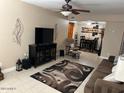 Inviting living room featuring a ceiling fan, entertainment center, and a cozy reading nook at 839 S Westwood S -- # 169, Mesa, AZ 85210