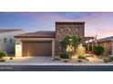 Charming home featuring stone accents, a well-manicured yard, and a two-car garage at 8691 E Eastwood Cir, Carefree, AZ 85377