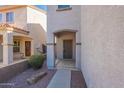 Inviting entrance with a covered doorway, desert landscaping, and a secure gate at 8854 W Aster Dr, Peoria, AZ 85381