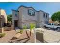 Well-maintained townhome with attached two-car garage and low-maintenance desert landscaping at 8854 W Aster Dr, Peoria, AZ 85381