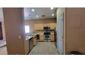 Functional kitchen features wood cabinets, stainless steel appliances, and tile flooring at 8854 W Aster Dr, Peoria, AZ 85381