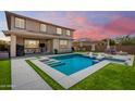 Beautiful backyard featuring a sparkling pool and lush green grass, ideal for outdoor entertainment at 9342 W White Feather Ln, Peoria, AZ 85383