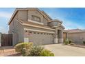 Charming two-story home with a well-manicured desert rock landscape in front at 10351 W Carlota Ln, Peoria, AZ 85383