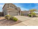 Charming two-story home with a well-manicured desert rock landscape in front at 10351 W Carlota Ln, Peoria, AZ 85383